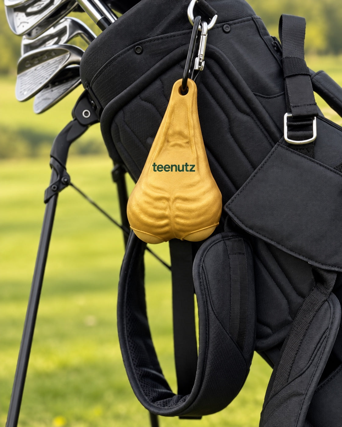 Gold teenutz golf-ball holder attached to a black golf bag